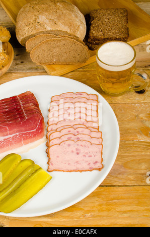 Cold meat, pickles, whole wheat bread and beer, a traditional German cold meal Stock Photo