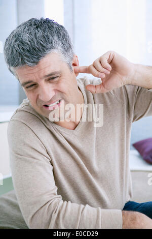 Ear pain in a man Stock Photo