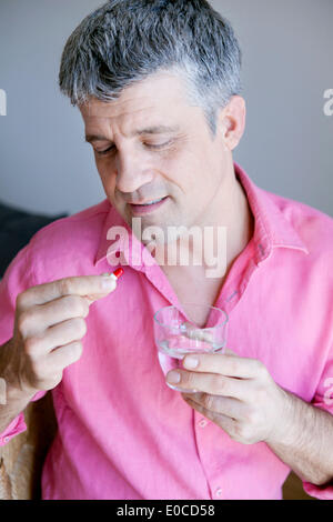 Man taking medication Stock Photo