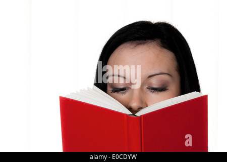 Woman with book while reading before a white background, Frau mit Buch beim Lesen vor einem weissen Hintergrund