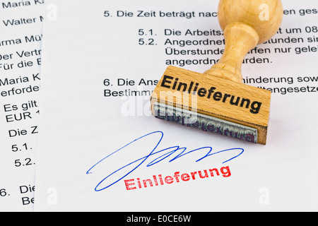 A stamp of wood lies on a document. Label Admission, Ein Stempel aus Holz liegt auf einem Dokument. Aufschrift Einlieferung Stock Photo