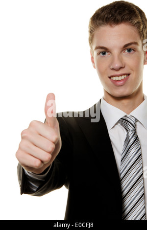 A successful young man holds up thumb, Ein erfolgreicher junger Mann haelt Daumen hoch Stock Photo