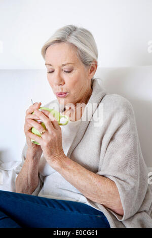 Elderly person with hot drink Stock Photo