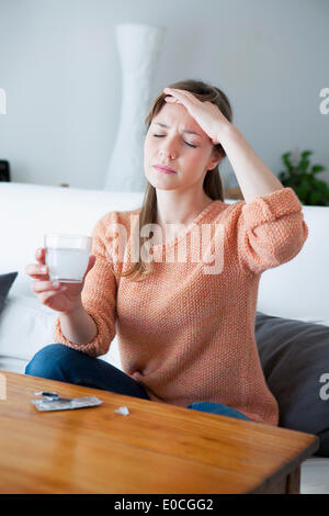 Woman taking medication Stock Photo