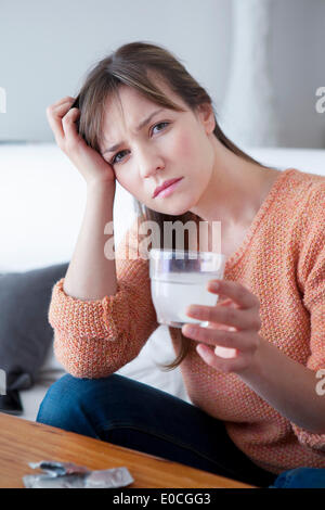 Woman taking medication Stock Photo