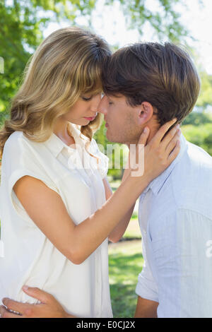 Cute couple hugging and kissing in the park Stock Photo - Alamy