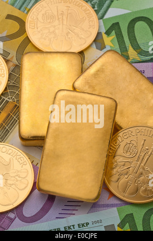 Investment in real gold as a gold bar and coins Stock Photo