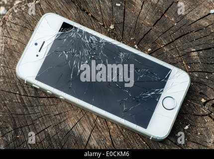 Broken white iphone glass on wood Stock Photo