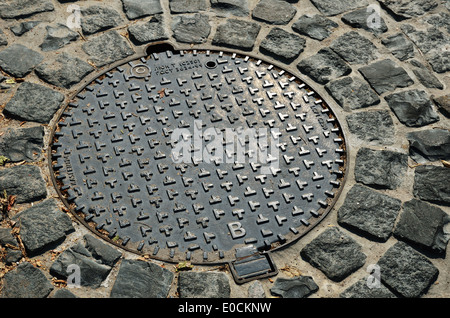 Sewer manhole on the stone pavement Stock Photo