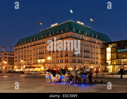 Horse drawn carriage in front of Adlon Hotel at night, Parisian Square, Unter den Linden, Mitte, Berlin, Germany, Europe Stock Photo