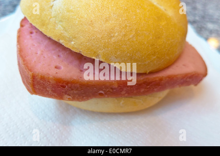 A liver cheese bun lies on a napkin. Fastfood is injurious, Eine Leberkaessemmel liegt auf einer Serviette. Fastfood ist ungesun Stock Photo