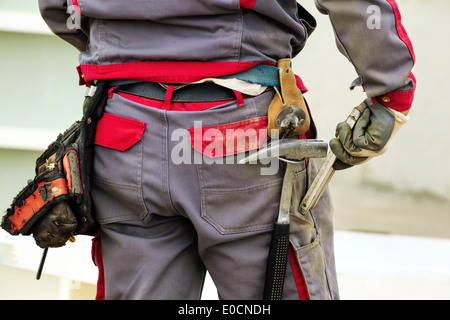 The belt with tools of a construction worker on a building site, Der Gaeuertel mit Werkzeug eines Bauarbeiters auf einer Baustel Stock Photo