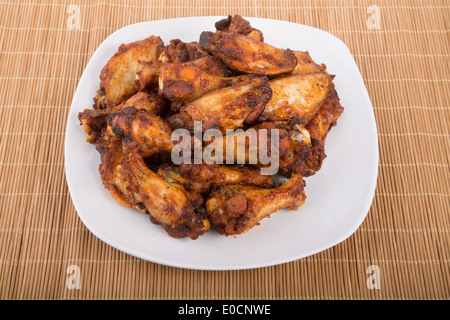 Fried chicken wings with mesquite sauce on a white plate Stock Photo