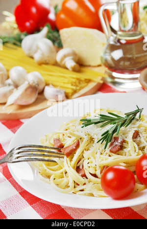 Pasta carbonara in the white plate on the wooden table Stock Photo