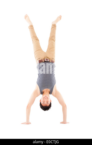 young man doing a handstand against on white background Stock Photo