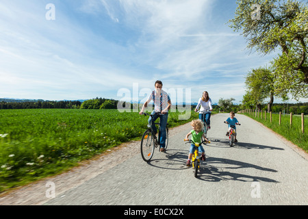 Family cycling, Upper Bavaria, Germany Stock Photo