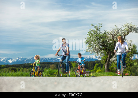 Family cycling, Upper Bavaria, Germany Stock Photo