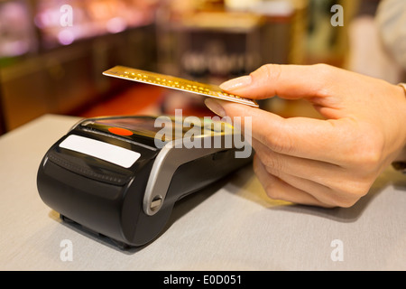 Female paying credit card shop butcher Stock Photo