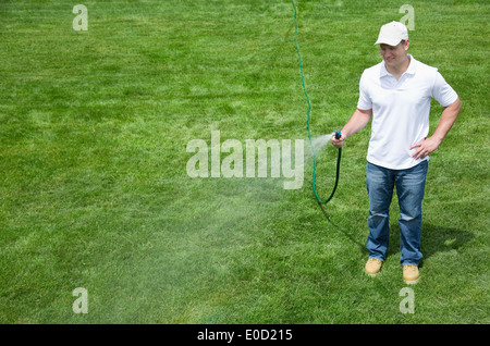 Man watering lawn Stock Photo