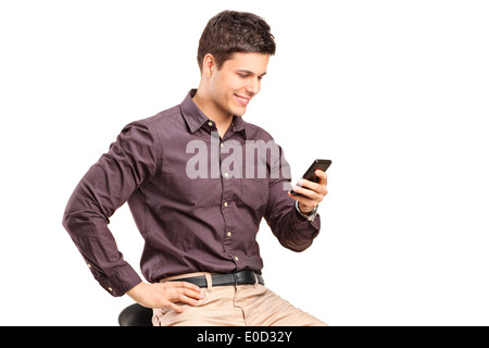 Fashionable man texting by a cell phone Stock Photo