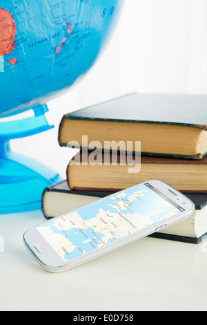 Smartphone and stack of books Stock Photo
