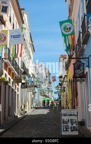 SALVADOR, BRAZIL - OCTOBER 15, 2013: Visitors walk along the cobblestone streets of the colorful historic center of Pelourinho. Stock Photo