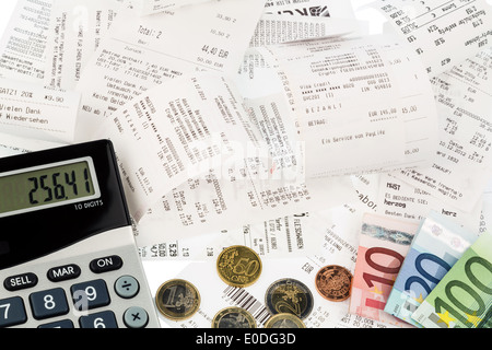 Pocket calculator, receipts and money, symbolic photo for saving, buying power and inflation, Taschenrechner, Kassenbons und Gel Stock Photo