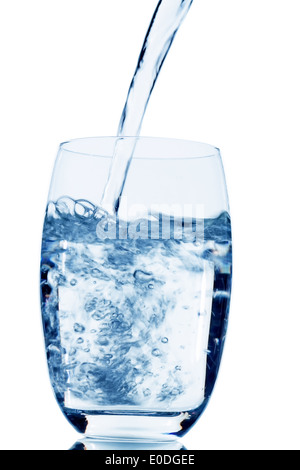 Water is poured in a glass, symbolic photo for drinking water, freshness, need and consumption, Wasser wird in ein Glas gegossen Stock Photo