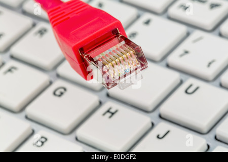 Network cable on keyboard, symbolic photo for Flatrate, e-commerce, global communication, Netzwerkkabel auf Tastatur, Symbolfoto Stock Photo