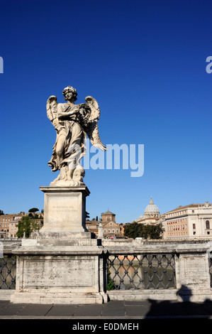 Italy, Rome, angel statue on Sant'Angelo bridge and St Peter basilica, angel with the crown of thorns Stock Photo