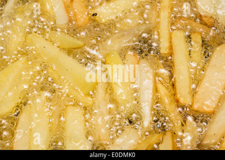 French Fries Boiling In Hot Oil Stock Photo