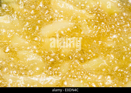 Preparing French Fries In Hot Boiling Oil With Fresh Potato Chips Stock Photo