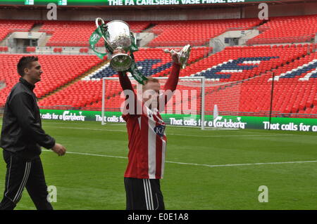Mike Carter of Sholing Town FC  celebrates on the pitch with the 2014 FA Vase held aloft at Wembley Stadium, London, UK.  Sholing Town FC are based in Hampshire and are this year's Champions of the Wessex Premier League played West Auckland Town FC who are based in County Durham and finished 5th in the second oldest football league in the world, in an absorbing final, with Sholing Town FC taking the honour of  lifting the FA Vase at Wembley. Wembley Stadium, London, UK. 10th May, 2014 Credit:  Flashspix/Alamy Live News Stock Photo