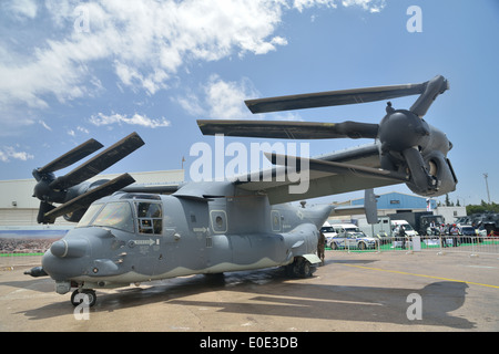 MV-22B Osprey tilt rotor vertical lift aircraft flies whit fold blades