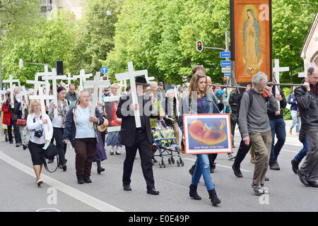 MUNICH, GERMANY – MAY 10, 2014:  Anti-Abortion Demonstration with participants carrying Christian Crosses and banners.