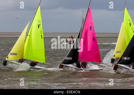 West Kirby, Liverpool. 10th May, 2014.  British Open Team Racing Championships Trophy 2014.  Sailing’s Premier League ‘The Wilson Trophy’ 200.  Olympic-class sailors, club, boat yacht, sea, race, water, boat, sail, ship, nautical, sport, travel, sailboat, yachting, ocean, wind, summer, regatta, blue, speed, wave, vessel, lifestyle, recreation, landscape, tourism, maritime, activity, crew, boating, sailing, competing annually on Kirby’s marine amphitheatre in one of the World’s favourite events hundreds of spectators follow 300 short, sharp frenzied races in three-boat teams jostling on the mar Stock Photo