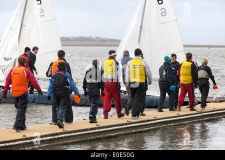 West Kirby, Liverpool. 10th May, 2014.  Competitors on the boat jetty at the British Open Team Racing Championships Trophy 2014.  Sailing’s Premier League ‘The Wilson Trophy’ 200 Olympic-class sailors compete annually on Kirby’s marine amphitheatre in one of the World’s favourite events where hundreds of spectators follow 300 short, sharp frenzied races in three-boat teams jostling on a marina lake the size of a football field to earn the coveted title: “Wilson Trophy Champion.” Credit:  Cernan Elias/Alamy Live News Stock Photo