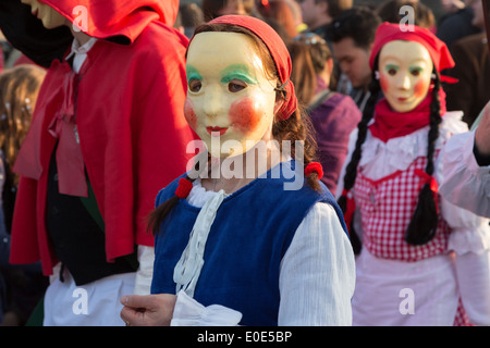 A photograph of an anonymous girl wearing a beautiful red riding hood costume at a carnival parade. Stock Photo
