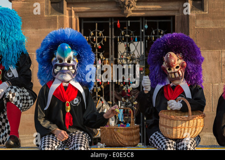 A photograph of some colorful masks and costumes at Basler Fasnacht (carnival). This particular one is known as a Waggi. Stock Photo