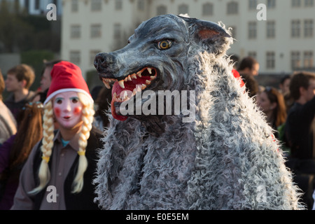 A photograph of someone anonymous wearing a wolf costume at a carnival parade. Stock Photo