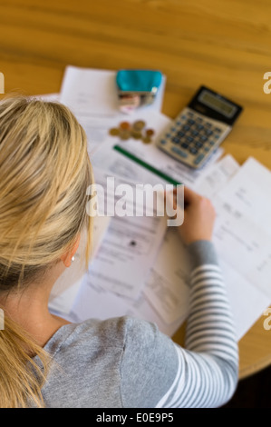 A woman with open calculations has many debts Stock Photo