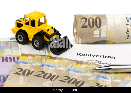 A bill of sale for new excavator. Invest in new vehicles brings cost advantages. With Swiss Franconia, Ein Kaufvertrag fuer neue Stock Photo