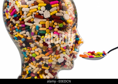 A head of glass with many tablets full. Symbolic photo for drugs, abuse and tablet addiction., Ein Kopf aus Glas mit vielen Tabl