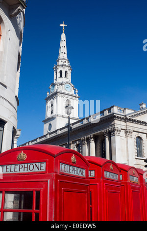 St Martin in the Fields church with traditional classic red K6 telephone phone boxes in foreground London England UK Stock Photo