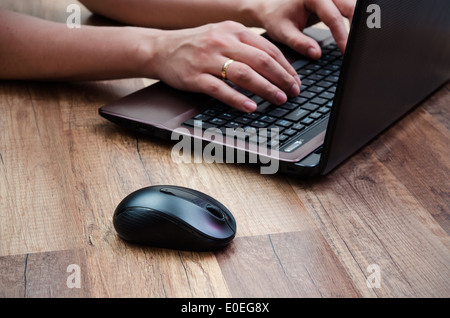 Man working with laptop on wooden background Stock Photo