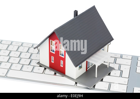 Dwelling house on keyboard, symbolic photo for house purchase and renting on the Internet, Wohnhaus auf Tastatur, Symbolfoto fue Stock Photo