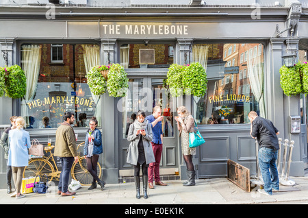 People chatting and relaxing outside Marylebone Railway station London ...