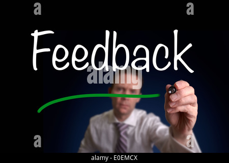 A businessman writing contact us on a screen. Stock Photo