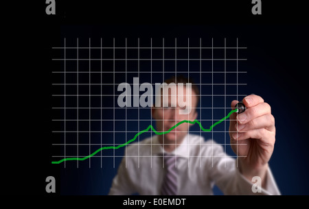 Businessman hand drawing a virtual chart on a clear screen. Stock Photo