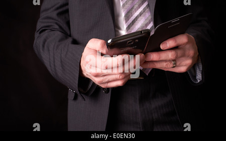 A business man writing a message with a stylus on an electronic device. Stock Photo